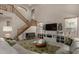 Spacious living room featuring vaulted ceilings, a staircase with wood banisters, and large windows for plenty of natural light at 1101 S Hazel St, Gilbert, AZ 85296