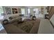 Inviting living room with large sofa, stylish rug and view to the kitchen area at 1101 S Hazel St, Gilbert, AZ 85296