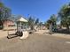 A neighborhood playground with shaded picnic tables, slides, climbing bars, and a sandbox at 1101 S Hazel St, Gilbert, AZ 85296