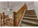 A carpeted staircase with wood railing leads to the second story of the home overlooking the living room at 1101 S Hazel St, Gilbert, AZ 85296