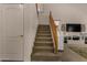 A carpeted staircase near a white door leads to the second story of the home at 1101 S Hazel St, Gilbert, AZ 85296