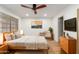 Bright bedroom features a ceiling fan, natural light, and a serene setting for relaxation at 1211 N Miller Rd # 129, Scottsdale, AZ 85257