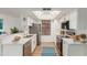 Well-lit kitchen boasts white cabinets, stainless steel appliances, ample counter space, and wood-look floors at 1211 N Miller Rd # 129, Scottsdale, AZ 85257