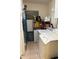 A cozy laundry area with appliances, tile floors and convenient storage shelving with pantry items at 2921 E Cheery Lynn Rd, Phoenix, AZ 85016