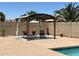 Relaxing backyard pergola with seating area; a tranquil poolside retreat at 40640 W Pryor Ln, Maricopa, AZ 85138