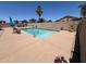 Spacious pool area with ample lounging space, desert landscaping, and privacy wall at 40640 W Pryor Ln, Maricopa, AZ 85138