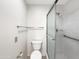 Bright, minimalist bathroom with tiled floors, a shower, and grab bars for accessibility at 10014 E Michigan Ave, Sun Lakes, AZ 85248