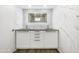 Modern bathroom vanity with double sinks, marble style walls and an illuminated mirror at 10014 E Michigan Ave, Sun Lakes, AZ 85248
