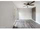 Spacious room with wood-look floors, neutral colors, and patio door access at 10014 E Michigan Ave, Sun Lakes, AZ 85248