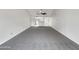 Bright living space with gray carpet and open access to the kitchen at 10014 E Michigan Ave, Sun Lakes, AZ 85248
