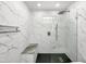 Modern bathroom features a tiled shower with a glass wall and built in bench seating at 10014 E Michigan Ave, Sun Lakes, AZ 85248