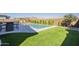 Lush backyard featuring a sparkling pool, artificial grass, and privacy landscaping for a relaxing outdoor experience at 10134 E Supernova Dr, Mesa, AZ 85212