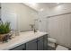 Bright bathroom with a white countertop, gray vanity, and decorative shower curtain at 10134 E Supernova Dr, Mesa, AZ 85212