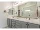 Bright bathroom featuring dual sinks, modern fixtures, and a subway tiled walk-in shower at 10134 E Supernova Dr, Mesa, AZ 85212