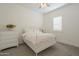 Bright bedroom with white furniture, neutral carpet, and natural light from the window at 10134 E Supernova Dr, Mesa, AZ 85212