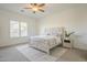 Well-lit bedroom featuring a patterned bedspread, nightstand, and shuttered windows at 10134 E Supernova Dr, Mesa, AZ 85212