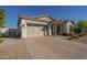 Well-maintained home featuring a spacious driveway, two car garage, and desert landscaping at 10134 E Supernova Dr, Mesa, AZ 85212