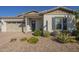 Charming single-story home featuring desert landscaping, a two-car garage, and inviting front entry at 10134 E Supernova Dr, Mesa, AZ 85212