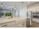 Modern kitchen boasts a white farmhouse sink, quartz counters, and stainless steel appliances at 10134 E Supernova Dr, Mesa, AZ 85212