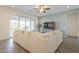 Bright living room boasting a large sectional, sliding glass doors, and an entertainment center at 10134 E Supernova Dr, Mesa, AZ 85212