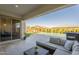 Covered patio with comfortable seating area, outdoor dining and a beautiful pool at 10134 E Supernova Dr, Mesa, AZ 85212