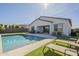 Inviting backyard oasis featuring a sparkling pool, lounge chairs, and a covered patio perfect for outdoor entertaining at 10134 E Supernova Dr, Mesa, AZ 85212