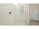 Walk-in shower featuring white subway tile, a glass enclosure, and a built-in bench at 10134 E Supernova Dr, Mesa, AZ 85212