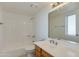 Clean bathroom featuring a tub and shower, vanity with a solid surface counter, and a large mirror at 10444 N 69Th St # 224, Paradise Valley, AZ 85253