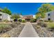 Front view of the building with desert landscaping, a concrete walkway, and a well-maintained facade at 10444 N 69Th St # 224, Paradise Valley, AZ 85253