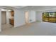 Bright living room featuring plush carpeting, a sliding glass door to the outside, and a small kitchen area at 10444 N 69Th St # 224, Paradise Valley, AZ 85253