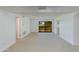 Spacious living room with bright white walls and plush carpeting, featuring a sliding glass door at 10444 N 69Th St # 224, Paradise Valley, AZ 85253