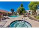 Inviting community pool and spa area surrounded by mature landscaping and lounge seating for relaxation at 10444 N 69Th St # 224, Paradise Valley, AZ 85253