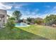 Large backyard featuring a swimming pool with a waterfall feature and lush green grass at 11502 E Rafael Ave, Mesa, AZ 85212