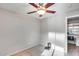 Bedroom with ceiling fan, neutral walls and flooring, and a home office nook nearby at 11502 E Rafael Ave, Mesa, AZ 85212