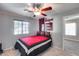 Bedroom with ceiling fan, a view to the hallway, and a Husker theme at 11502 E Rafael Ave, Mesa, AZ 85212