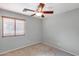 Neutral bedroom with wood-tone ceiling fan and window with wood-tone blinds at 11502 E Rafael Ave, Mesa, AZ 85212