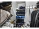 Organized walk-in closet featuring shelves, shoes, and folded jeans at 11502 E Rafael Ave, Mesa, AZ 85212