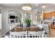 The dining area offers a view to the kitchen, living room, and fireplace with neutral colors at 11502 E Rafael Ave, Mesa, AZ 85212