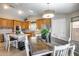 Warm, bright dining area offers wooden furniture, and access to the kitchen with stainless refrigerator at 11502 E Rafael Ave, Mesa, AZ 85212