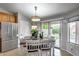 Cozy dining area with stainless steel refrigerator and a view of the backyard through sliding glass doors at 11502 E Rafael Ave, Mesa, AZ 85212