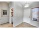 Welcoming entryway with tile flooring, decorative lighting, and a glimpse into the laundry room at 11502 E Rafael Ave, Mesa, AZ 85212
