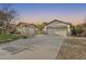 Well-manicured landscape showcasing the charming exterior, a two-car garage, and a single-car garage at 11502 E Rafael Ave, Mesa, AZ 85212