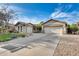 Attractive home featuring a neatly landscaped front yard, a long driveway, and an attached two-car garage at 11502 E Rafael Ave, Mesa, AZ 85212