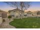 Front yard featuring an expansive artificial turf lawn and a gravel perimeter at 11502 E Rafael Ave, Mesa, AZ 85212