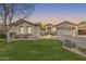 Charming single-story home featuring a low-maintenance xeriscape yard with artificial turf and mature landscaping at 11502 E Rafael Ave, Mesa, AZ 85212