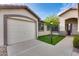 Close up of house including a garage, some grass and a tree at 11502 E Rafael Ave, Mesa, AZ 85212