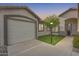 Attached two-car garage with extra parking space featuring a well maintained landscape at 11502 E Rafael Ave, Mesa, AZ 85212