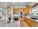 Bright kitchen with stainless appliances, wood cabinets and sleek countertops, with a double oven at 11502 E Rafael Ave, Mesa, AZ 85212