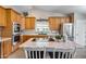 Well-equipped kitchen features wood cabinets, stainless steel appliances, and a central island with seating at 11502 E Rafael Ave, Mesa, AZ 85212