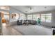 Spacious living room boasts plush carpeting, a ceiling fan, and large windows showcasing the outdoor pool at 11502 E Rafael Ave, Mesa, AZ 85212